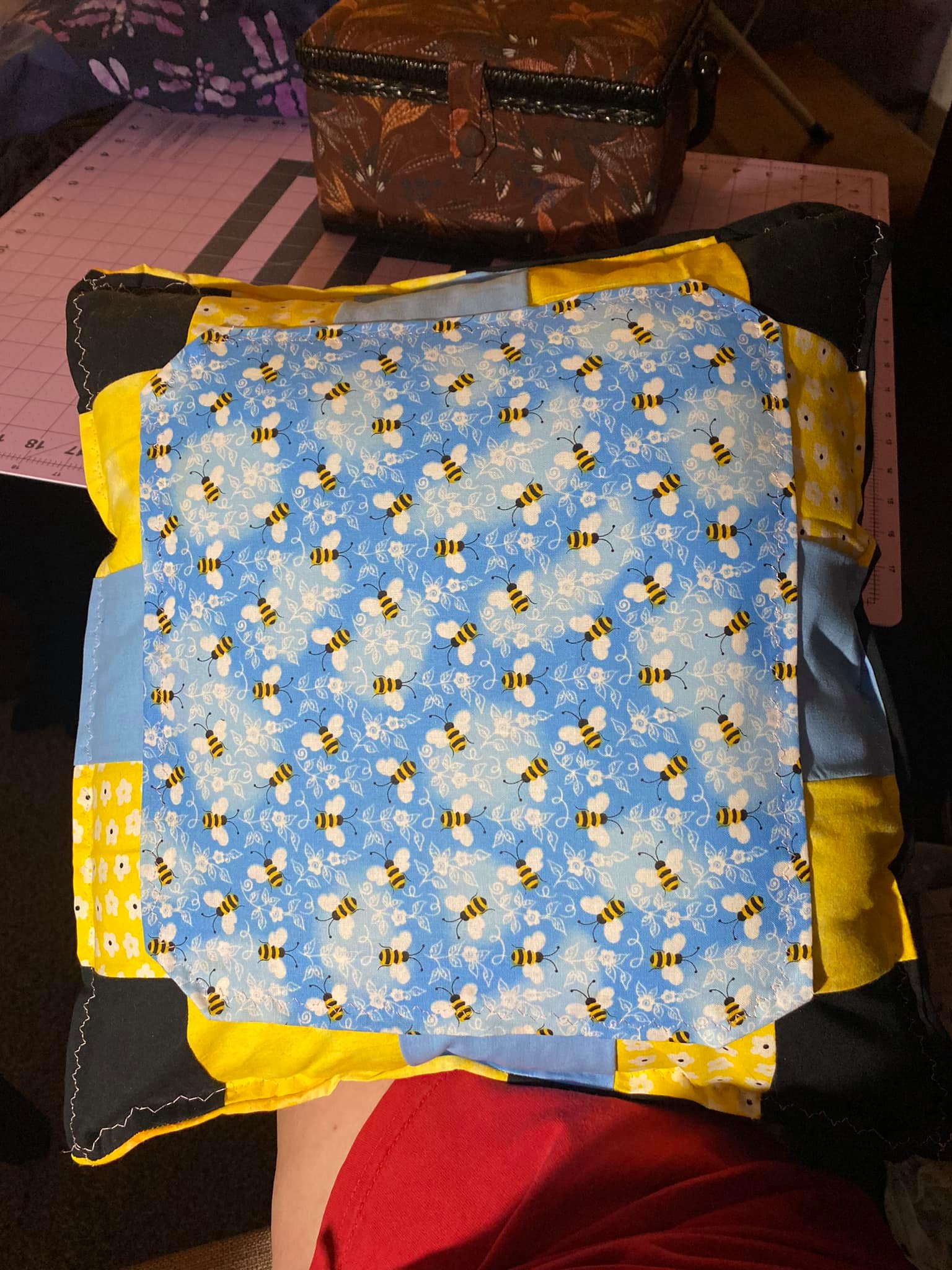A pillow with bees on it