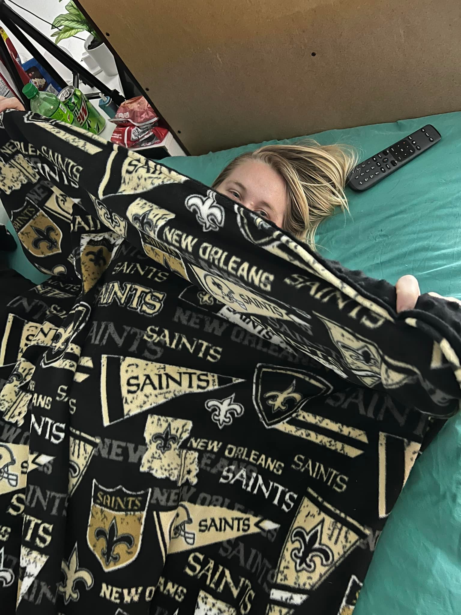 A happy customer under a Saints blanket